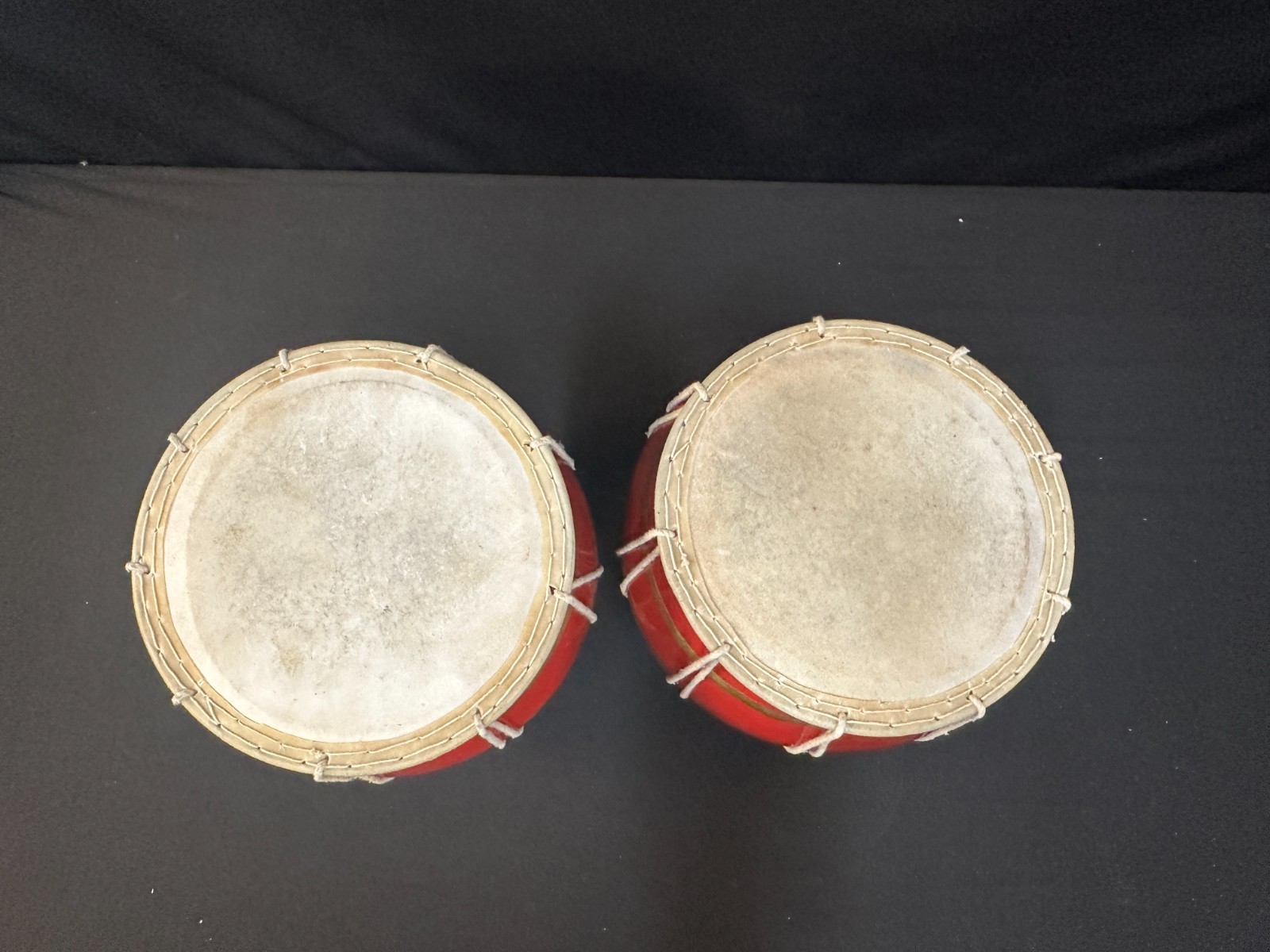 9" diameter pair of hand red and painted hand drums, low and high, w/ cushions. - Image 2